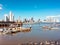 Panama City Cityscape and skyline behind old fisher boats at fish market / harbor -