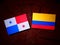 Panamanian flag with Colombian flag on a tree stump isolated