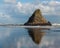 Panatahi Island reflecting on wet beach