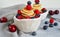 Pancake cereal, mini pancakes in a bowl with blueberries, raspberries, cherries. Healthy nutrition. Culinary trend