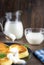 Pancake cheese with a jug and a glass of milk for breakfast on a gray plate, in a rustic style, close-up, sour cream