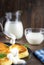 Pancake cheese with a jug and a glass of milk for breakfast on a gray plate, in a rustic style, close-up, sour cream