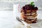 Pancake chocolate cake with curd white filling and cherry sauce on a light background. Selective focus