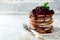 Pancake chocolate cake with curd white filling and cherry sauce on a light background. Selective focus