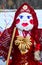 Pancake doll in red costume and knitted shawl with bagels