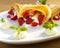 Pancake filled with strawsberries and garnished with mint, syrop and whipped cream