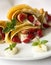 Pancake filled with strawsberries and garnished with mint, syrop and whipped cream