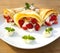 Pancake filled with strawsberries and garnished with mint, syrop and whipped cream