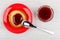 Pancake with jam in saucer, bowl with strawberry jam, spoon