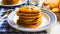 Pancake with pumpkin and cherry. Blue tablecloth. Tablecloth in a cage