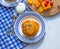 Pancake with pumpkin and cherry. Blue tablecloth. Tablecloth in a cage