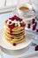 Pancake tower with cranberry marmalade  fresh cottage cheese and coffee for breakfast on mirror