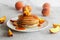 Pancakes with apricot jam and peaches. Pancakes on a plate