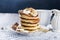Pancakes with banana, nuts ,honey and cup coffee on dark background