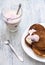 Pancakes with berry yoghurt in a white bowl on a wooden table. Yogurt with currants in the glass.