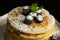 Pancakes with blueberries and icing sugar on an old aluminum pan