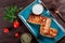 Pancakes with chopped meat and sour cream on dark wooden background close up.