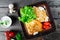 Pancakes with chopped meat and sour cream on dark wooden background close up. Traditional Russian cuisine at the Pancake week