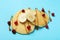 Pancakes with cranberry, banana and caramel on blue background