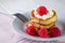 Pancakes with custard and raspberries