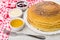 Pancakes in dish, strawberry jam, honey, condensed milk, fork, n