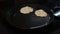 Pancakes are fried in a pan on an induction stove