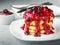 Pancakes or fritters with raspberry and blackcurrant jam, delicious dessert for breakfast