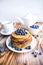 Pancakes healthy breakfast with blueberries, bog whortleberry, cup of green tea, cup of blueberries and teapot