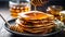 pancakes with honey. Lots of fritters on the plate. Hot pastries for breakfast. Against the background of the kitchen.