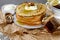 Pancakes with honey and sour cream and walnuts on a paper napkin