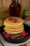 Pancakes hotcakes with berries and fruit served with maple syrup