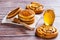 Pancakes with liquid honey on wooden background