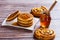 Pancakes with liquid honey on wooden background