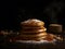 Pancakes with maple syrup and sugar powder on a black background