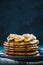 Pancakes pile with banana,walnuts and maple syrup.Copy space