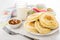 Pancakes in plate, napkin, bowl with apricot jam, milk