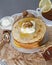 Pancakes with sour cream and honey, decorated with walnut.
