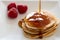Pancakes stake with golden syrup and strawberries