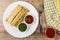 Pancakes with stuffing in plate, fork, tomato juice in glass