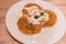 Pancakes on a white plate Resting on a wooden table