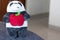 Panda plush toy holding a red apple with a happy face