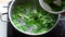 Pandan drink making, pouring pandan leaf into boiled water