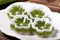 Pandan jelly in a white plate on a wooden background
