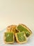 Pandan seed moon cake, one whole, with portion cutout, on a beige background.