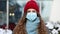 Pandemic coronavirus covid concept. Curly brunette woman in surgical protective mask for corona virus second outbreak