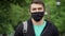 Pandemic coronavirus protection. Portrait of european hipster man wearing protective mask on street