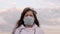 Pandemic Coronavirus. woman tourist wearing a protective mask on the street. Protection against viruses and bacteria