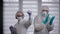 Pandemic Covid-19. Cheerful medical workers dance and rejoice. Funny people in protective suits