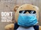 Pandemic covid19 new normal concept. A bear wearing surgical face mask with text don& x27;t forget your mask guys.