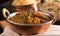 Paneer Butter Masala in a brass bowl.